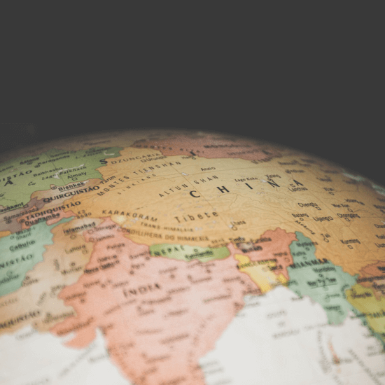 Close-up view of a globe against dark background, emphasizing the world's geography.