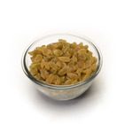 A bowl filled with plump raisins against a white background, showcasing their rich brown color and texture.