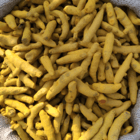 Thick turmeric sticks resting in a jute bag.